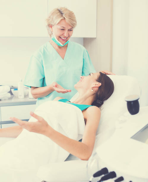 istock Cosmetician explaining treatment to patient 937398544