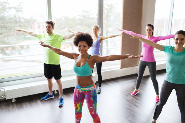 istock group of smiling people dancing in gym or studio 937399234