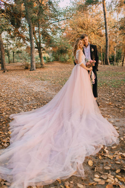 istock newlyweds walking in the woods at sunset 937399646