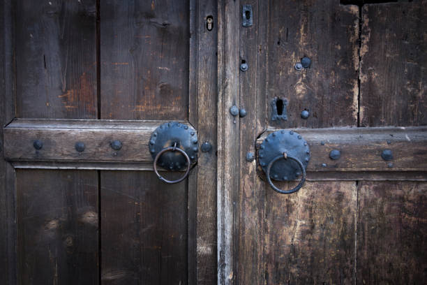 istock Wooden front door with decorated metal lock 937404212