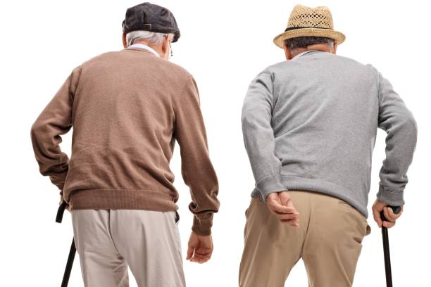 istock Rear view shot of two elderly men with canes 937406758