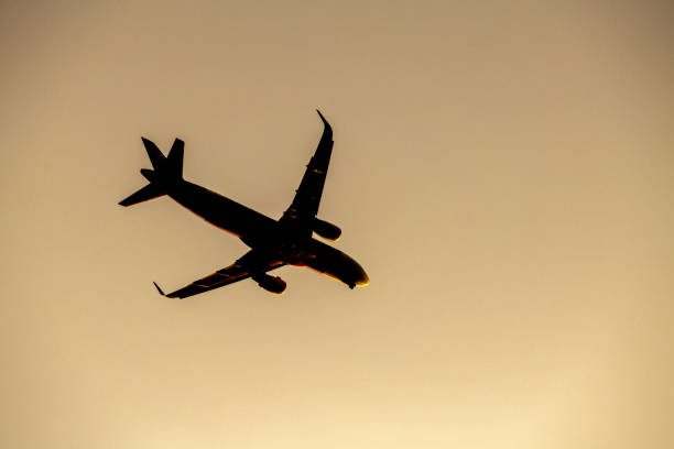 istock Airplane take off silhouette with sunlight in background. 937407704