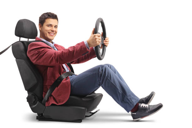 istock Elegantly dressed man in a car seat driving and looking at the camera 937407936