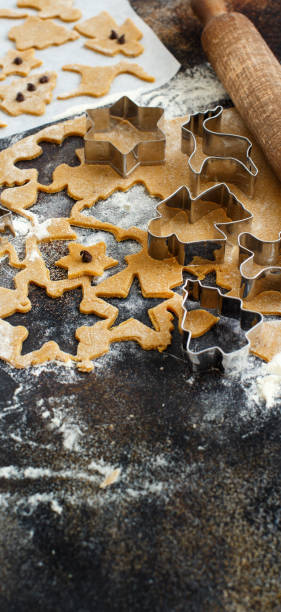 istock Cooking Christmas cookies with  cookie cutters 937411116