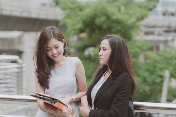 istock Two beautiful confident asian business woman taking a coffee break during break time. 937411690