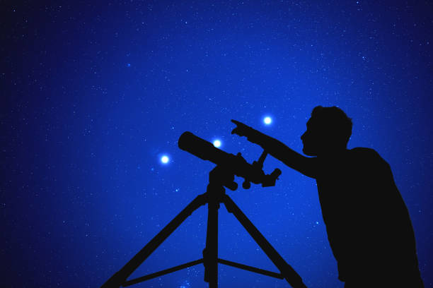 istock Man with a telescope watching stars. Elements of this image are my work. 937412490