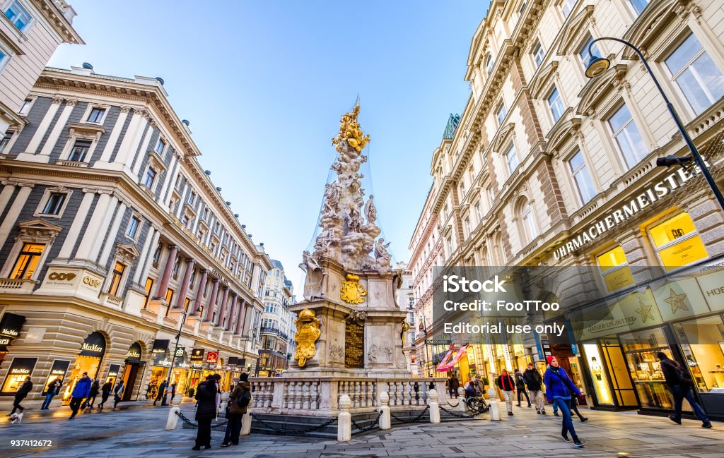 shopping street in vienna - austria VIENNA, AUSTRIA - JANUARY 17: crowded streets in the city center of Vienna, Austria. Colorful illuminated stores, shops and restaurants at the Grabenstrasse on January 17, 2018 in Vienna, Austria Pestsäule - Vienna Stock Photo