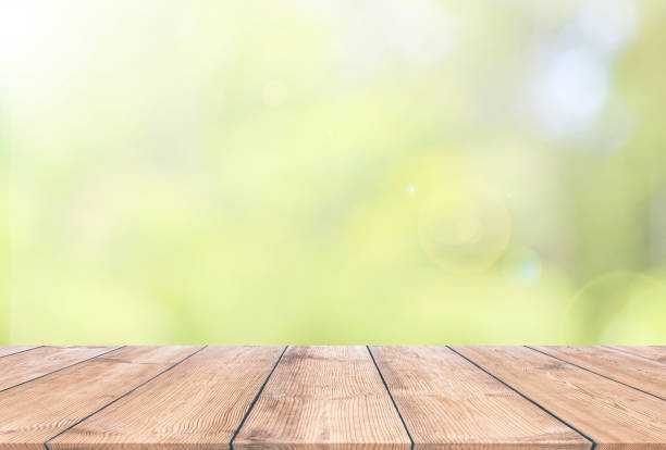 istock Wooden plank with natural green bokeh background 937414904