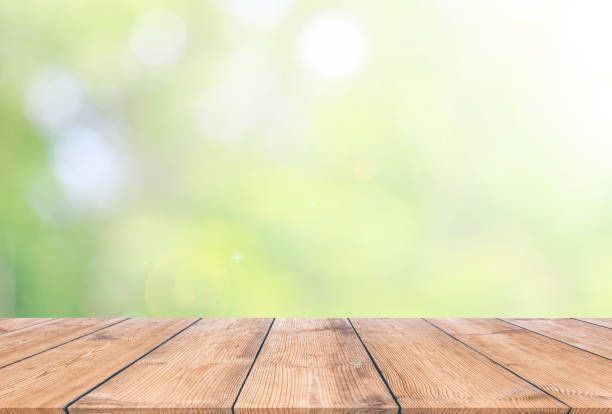 istock Wooden plank with natural green bokeh background 937415356