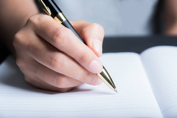 istock Business man Hands with pen writing on paper 937415838