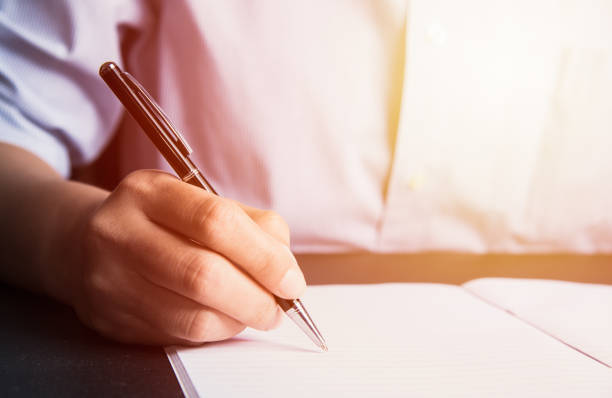 istock Business man Hands with pen writing on paper 937415944
