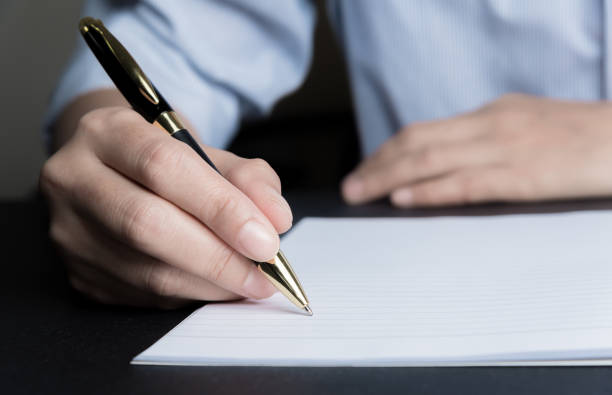 istock Business man Hands with pen writing on paper 937416336
