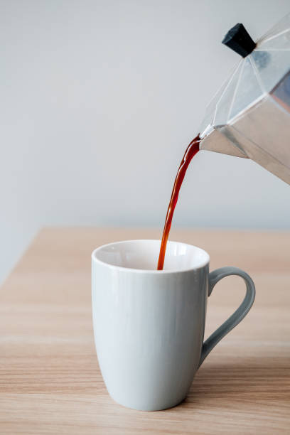 istock Coffee is poured into a mug from a coffee pot 937419196