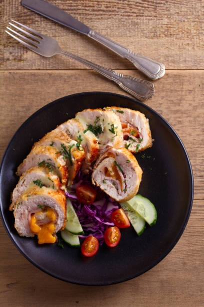istock Chicken Cordon Bleu. Chicken breast wraps with ham and cheese 937420026
