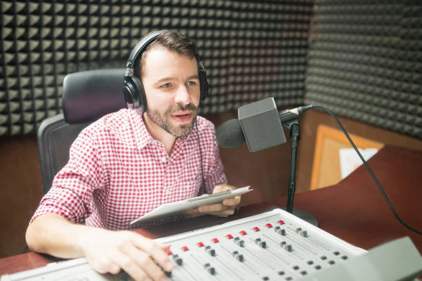 Radio jockey hosting show live on radio Handsome young man with beard hosting show live on radio station radio dj stock pictures, royalty-free photos & images