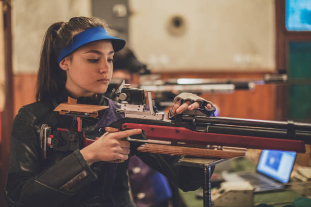 istock Girls on sport shooting practice 937436460