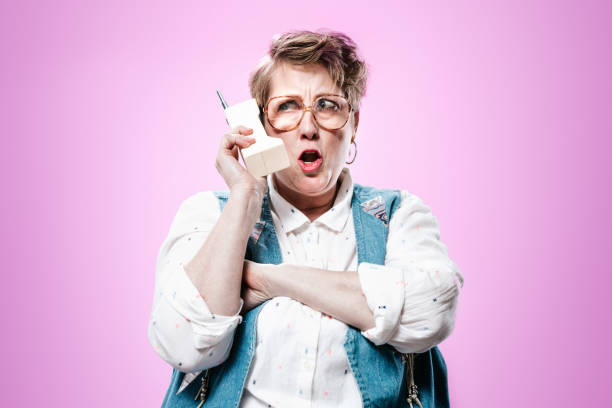 istock Nineties Styled Woman Talking on Mobile Brick Phone 937443856