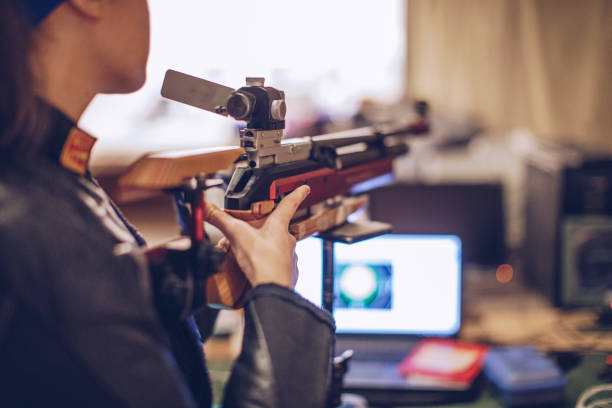 istock Young woman on rifle shooting practicing 937443974