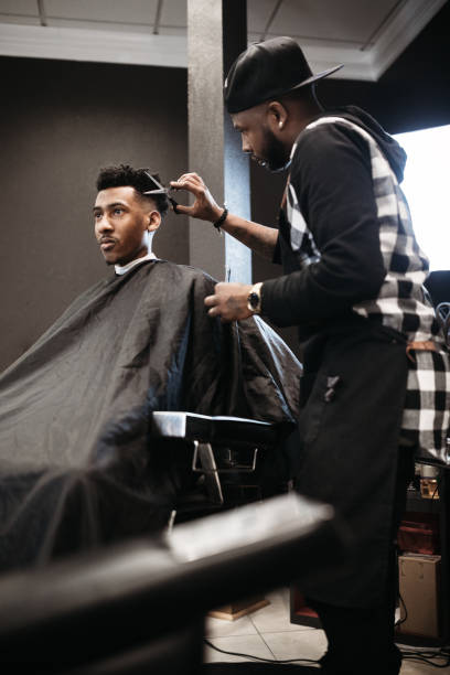 istock Barber Giving A Haircut in His Shop 937444100