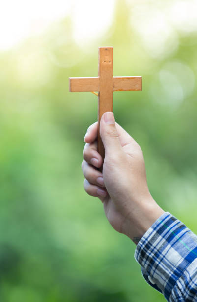 istock Hand up the cross, pray for god 937446792