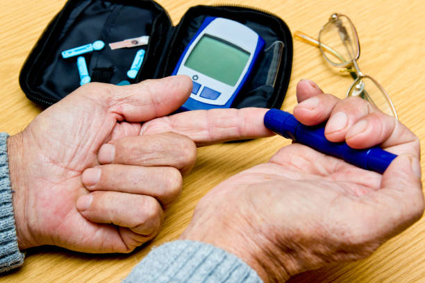 istock Concept diabetes in the elderly retired. Senior man with glucometer checking blood sugar level at home. Learn to use a glucometer 937450720