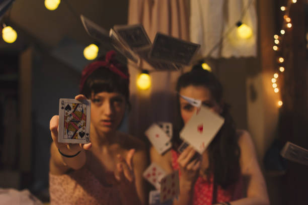 Two women in a messy house making a ritual with cards for happy love