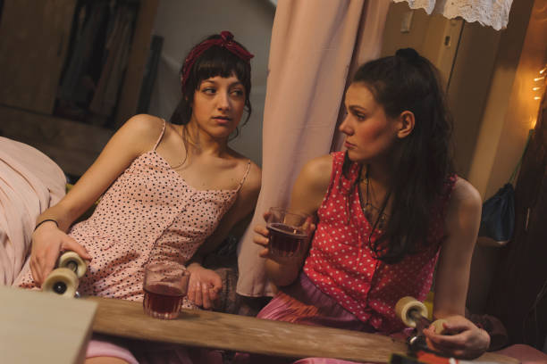istock Two young women drinking alcohol together 937450928