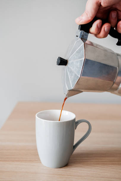 istock Coffee is poured into a mug from a coffee pot 937463002
