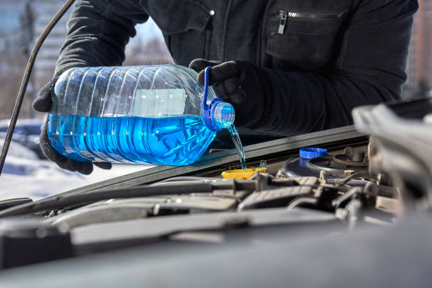 istock Filling a windshield washer tank of a car 937463228