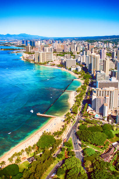 Aerial View of Honolulu Hawaii The skyline and coast of Honolulu and Waikiki on Oahu, Hawaii shot from an altitude of about 1000 feet over the Pacific Ocean. honolulu stock pictures, royalty-free photos & images