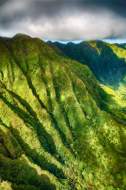 The beautiful and unique landscape of a mountain side on Oahu, Hawaii shot from an altitude of about 1000 feet over the mountains along the north shore.
