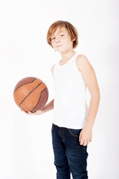 istock young blond boy holding a basketball 937466626