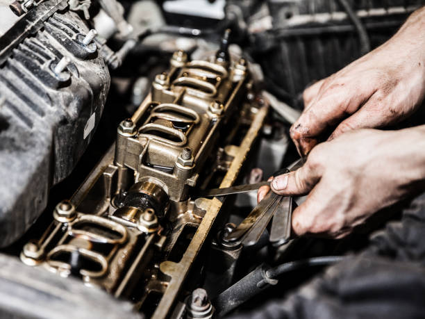 istock Automobile service worker or garage mechanic repairing auto car engine 937477862