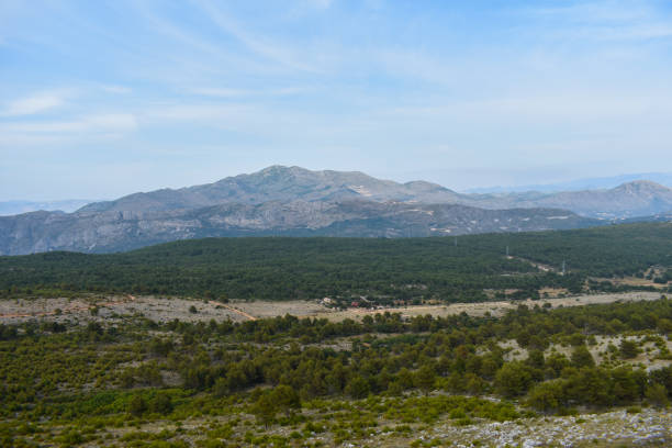 istock Beautiful landscape over grassy fields mountains on background in croatia 937484018