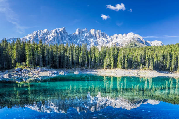 lago di carezza in springtime - latemar mountain range foto e immagini stock