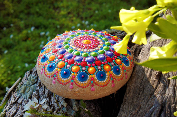 istock Hand painted mandala stone with yellow flowers 937504180