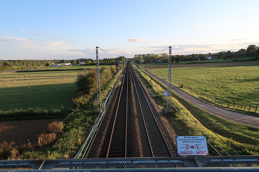 Saint Martin Belle Roche, France – September 15, 2017: photography showing some railway with view on the countryside. The photography was taken from the street of a small town near the city of Mâcon.