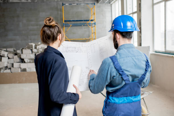 istock Builder with businesswoman at the construction site 937504994