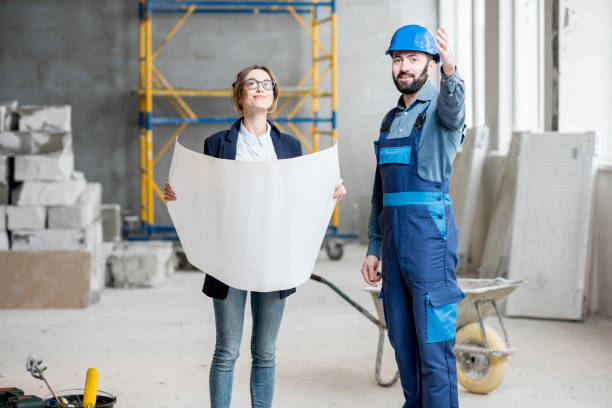 istock Builder with businesswoman at the construction site 937505238