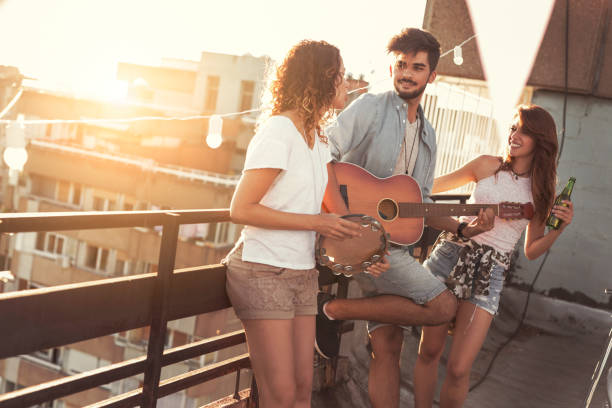 istock Friends playing the guitar and singing 937510372