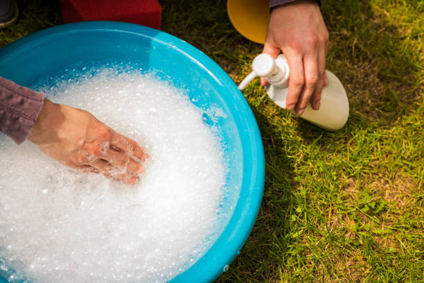 istock White soap bubbles foam on blue tub 937510644