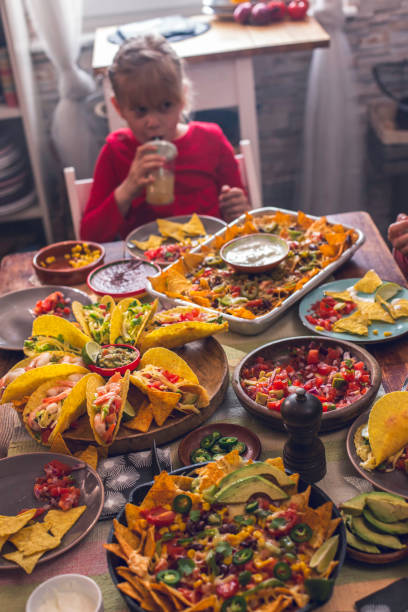 istock Eating Mexican Tacos with Spicy Salsa and Nacho Tortilla Chips 937522496