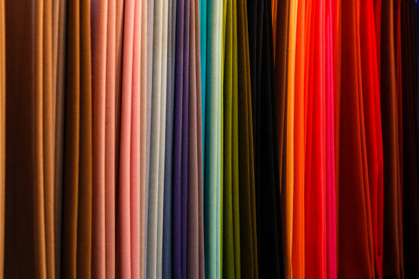 Rainbow clothes background. Pile of bright folded clothes.