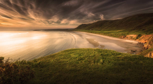 Rhossili Bay Sunset at Rhossili Bay on the Gower peninsula, Swansea, South Wales, UK, voted one of the top ten best beaches in Britain rhossili bay stock pictures, royalty-free photos & images