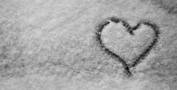 istock Winter. Hand Drawn Heart Shape in the fresh Snow. Black and White. Banner. 937528132