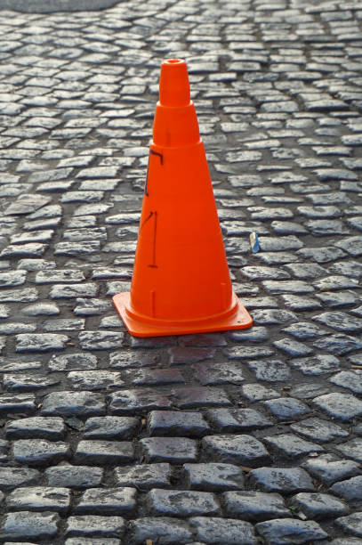 istock road cones in cobblestone street 937530946