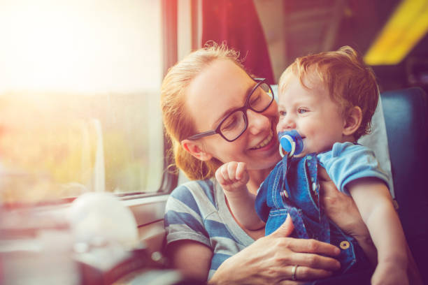 Family traveling by train Happy mother and her baby boy travelling in train in summer public transportation photos stock pictures, royalty-free photos & images