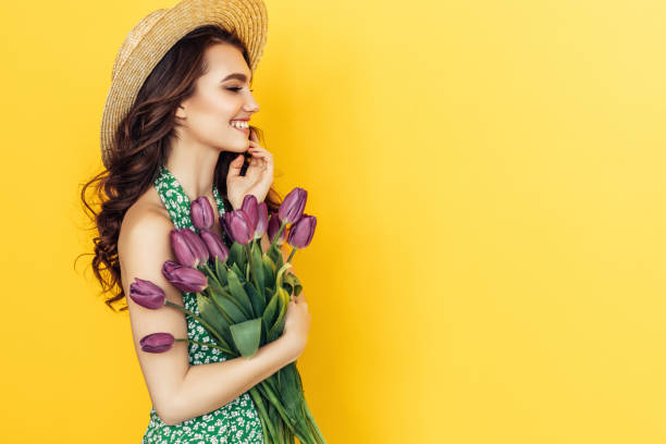 istock Lovely woman with purple tulips bunch 937536794