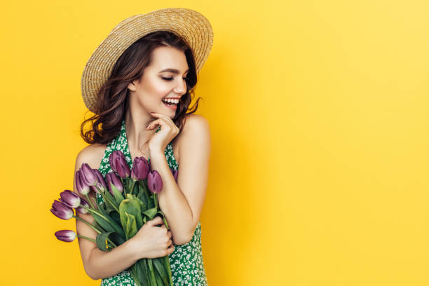 istock Lovely woman with purple tulips bunch 937536880