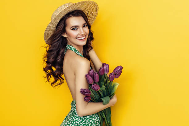 istock Lovely woman with purple tulips bunch 937536892